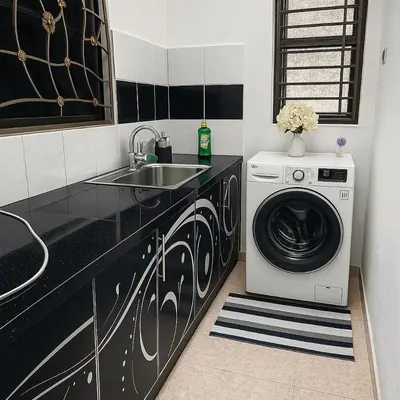 a kitchen with a washing machine and a sink at 4BR Near SPICE Arena Free Parking in Bayan Lepas