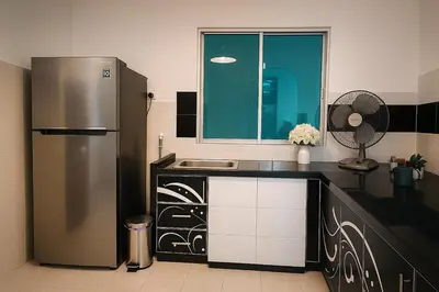 a kitchen with a refrigerator and a sink at 4BR Near SPICE Arena Free Parking in Bayan Lepas