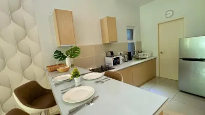 a kitchen with a white counter and a refrigerator at The Haven Lakeside Residences, Lake View Suite IPOH in Gua Sai