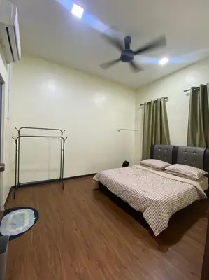 a bedroom with a bed and a ceiling fan at Mslim only Homestay Aleena Gua Musang in Gua Musang