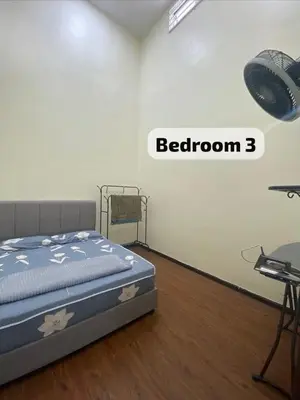 a bedroom with a bed in a room with a table at Mslim only Homestay Aleena Gua Musang in Gua Musang