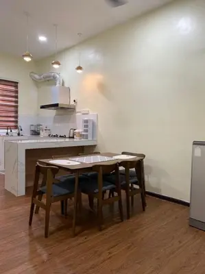 a kitchen with a table and chairs in a room at Mslim only Homestay Aleena Gua Musang in Gua Musang