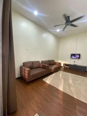 a living room with a couch and a ceiling fan at Mslim only Homestay Aleena Gua Musang in Gua Musang