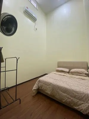 a bedroom with a bed and a fan at Mslim only Homestay Aleena Gua Musang in Gua Musang