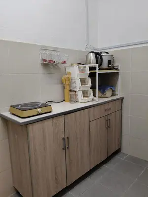 a kitchen with a counter top with some appliances at Almira Homestay in Brinchang