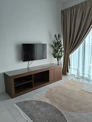 a living room with a flat screen tv on a cabinet at Almira Homestay in Brinchang