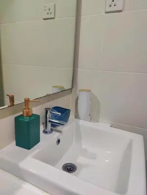 a white sink in a bathroom with a mirror at #MyMidoriGetaway , CameronFair, Cameron Highlands in Tanah Rata
