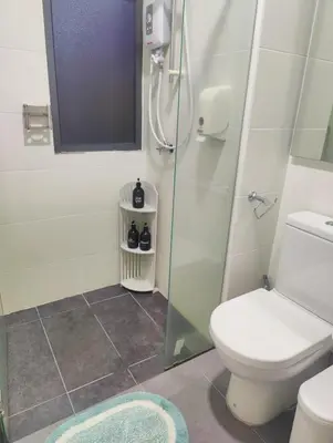 a bathroom with a toilet and a glass shower at #MyMidoriGetaway , CameronFair, Cameron Highlands in Tanah Rata