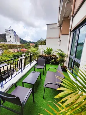 a balcony with chairs and tables on a building at #MyMidoriGetaway , CameronFair, Cameron Highlands in Tanah Rata