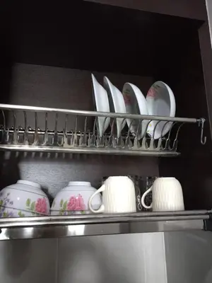 a shelf full of cups and saucers in a refrigerator at Oasis Condominiums Ipoh in Ipoh