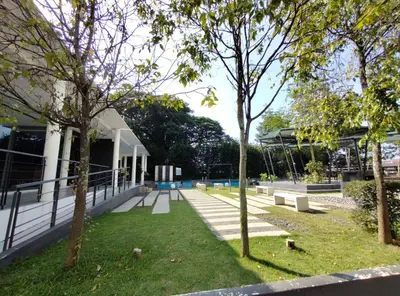 a park with benches and trees in front of a building at Oasis Condominiums Ipoh in Ipoh