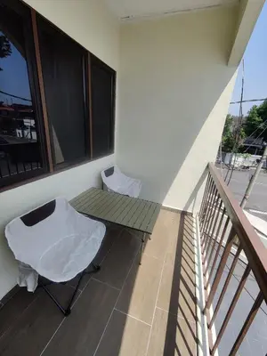 a balcony with a table and a bench on it at CLP perai homestay near Sri Muniswarar temple in Perai