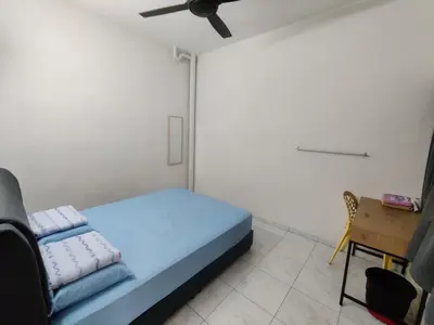 a small room with a bed and a chair at CLP perai homestay near Sri Muniswarar temple in Perai