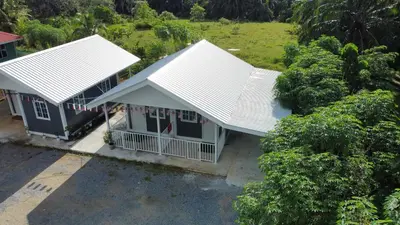 an overhead view of a house with two white roofs at al Hajari Inn - For Islam Only - Kg Banggol Batu Lenggong in Kampong Banggol Belimbing