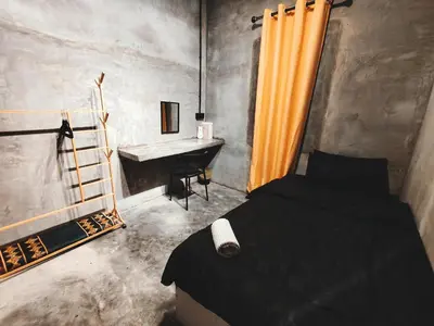 a bedroom with a bed and a sink and a desk at Afqa Nest Industrial Charm in Gua Sai