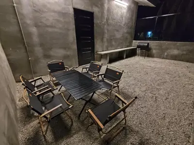 a group of chairs and a table in a room at Afqa Nest Industrial Charm in Gua Sai