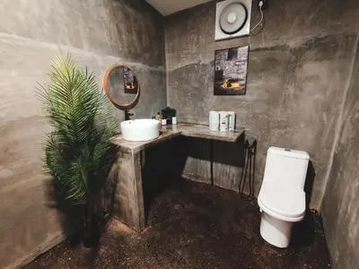 a bathroom with a sink and a toilet and a mirror at Afqa Nest Industrial Charm in Gua Sai