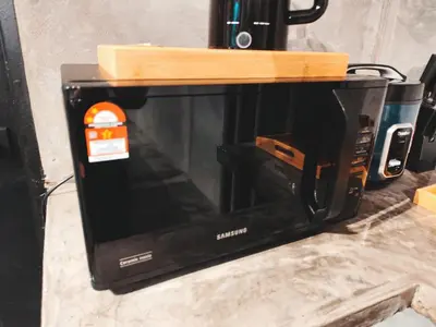 a microwave with a wooden top on top of it at Afqa Nest Industrial Charm in Gua Sai