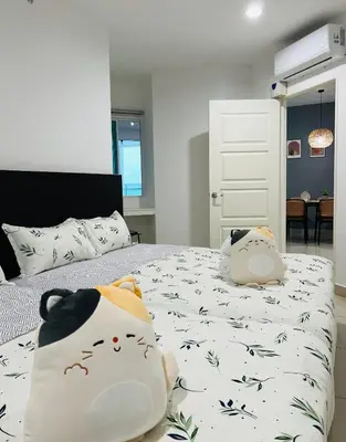 a bedroom with a bed with hello kitty pillows on it at Mansion One l 7pax 2R1B l Seaview l Gleneagles l by PerfectSweetHome in George Town