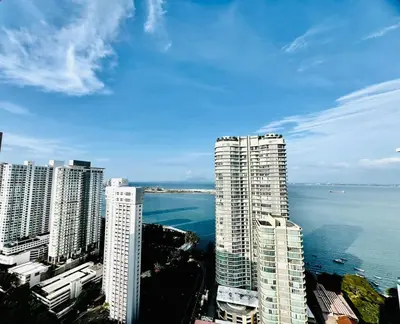 a group of tall buildings next to the ocean at Mansion One l 7pax 2R1B l Seaview l Gleneagles l by PerfectSweetHome in George Town