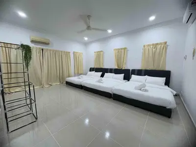 a bedroom with two beds and a ladder in it at 25 pax Golf Resort Private Villa in Kulim