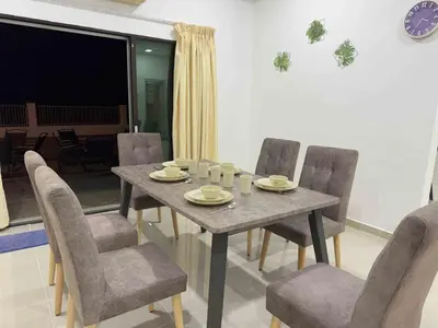 a dining room with a table and chairs at 25 pax Golf Resort Private Villa in Kulim