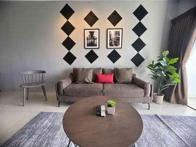 a living room with a couch and a table at Manhattan Ipoh Family Suites By Inn Lux in Ipoh