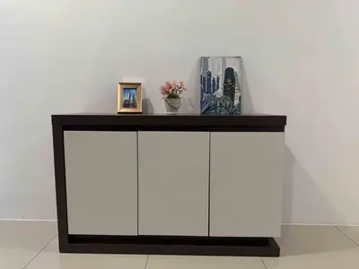 a white cabinet with a black top on a wall at Manhattan Ipoh Family Suites By Inn Lux in Ipoh