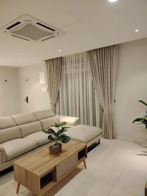 a living room with a couch and a coffee table at Relax Guest House Bakap Indah in Kampong Gurun