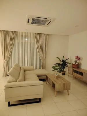 a living room with a couch and a table at Relax Guest House Bakap Indah in Kampong Gurun