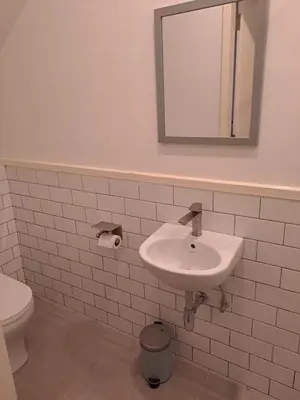 a white bathroom with a sink and a toilet at Georgetown vintage garden 5pax 2BR Homestay in George Town