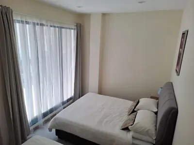 a bedroom with a bed and a large window at Georgetown vintage garden 5pax 2BR Homestay in George Town