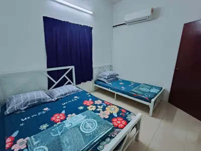 a bedroom with two beds and a window at Luna Homestay Lumut in Lumut