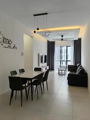 a dining room and living room with a table and chairs at The Glen Apartment Kuching in Gua Sai
