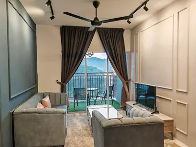 a living room with two couches and a large window at W907WarmStay at EmeraldAvenueBrinchang in Brinchang