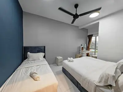 a bedroom with two beds and a ceiling fan at W907WarmStay at EmeraldAvenueBrinchang in Brinchang