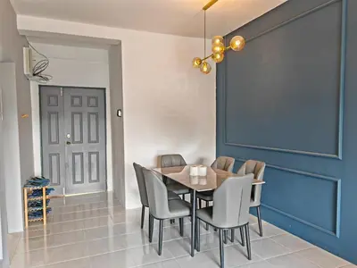 a dining room with a table and chairs and a blue door at W907WarmStay at EmeraldAvenueBrinchang in Brinchang
