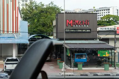 a street view of a mitzi outpost in a city at T+ Hotel Butterworth in Butterworth