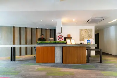 a lobby with a reception desk in a building at T+ Hotel Butterworth in Butterworth