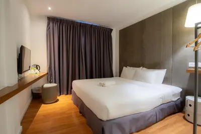 a hotel room with a white bed and a window at T+ Hotel Butterworth in Butterworth