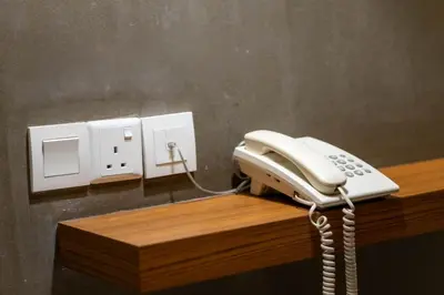 a white phone sitting on top of a desk at T+ Hotel Butterworth in Butterworth