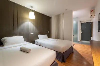 a hotel room with two beds in a room at T+ Hotel Butterworth in Butterworth