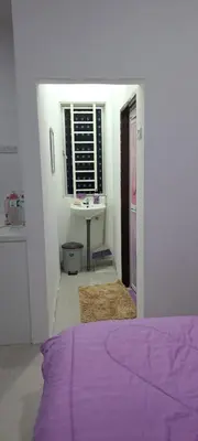 a bedroom with a purple bed and a sink at Teratak Sumayyah 1 - For Islam Only - Pondok Lenggong in Kampong Banggol Belimbing