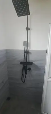 a room with a shower with a lamp in it at Teratak Sumayyah 1 - For Islam Only - Pondok Lenggong in Kampong Banggol Belimbing
