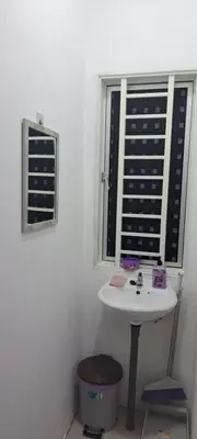 a bathroom with a sink and a window at Teratak Sumayyah 1 - For Islam Only - Pondok Lenggong in Kampong Banggol Belimbing