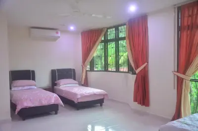 a room with two beds and two windows at Kulim LakeView Homestay at Golf Resort in Kulim