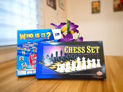 a chess set and a box of who is it chess set at Ipoh Happy Home Boutique Villa by City Home Empire in Ipoh
