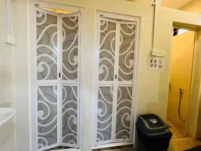 a bathroom with two shower doors in a room at MyRoom-Victoria, near to Island,LGL,Jln Burmah in George Town