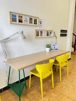 a table with two yellow chairs and a lamp at MyRoom-Victoria, near to Island,LGL,Jln Burmah in George Town