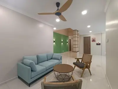 a living room with a blue couch and a table at Hejau Golf Villa in Tanah Rata